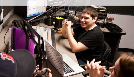 Alex Danahy, a senior communication major, sits in Studio A at WMLN, Curry's student-run radio station. // Photo courtesy of Curry College