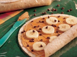 Take a soft tortilla, add peanut butter, banana slices and chocolate chips, then roll. It's sweet, modestly healthy, and good.